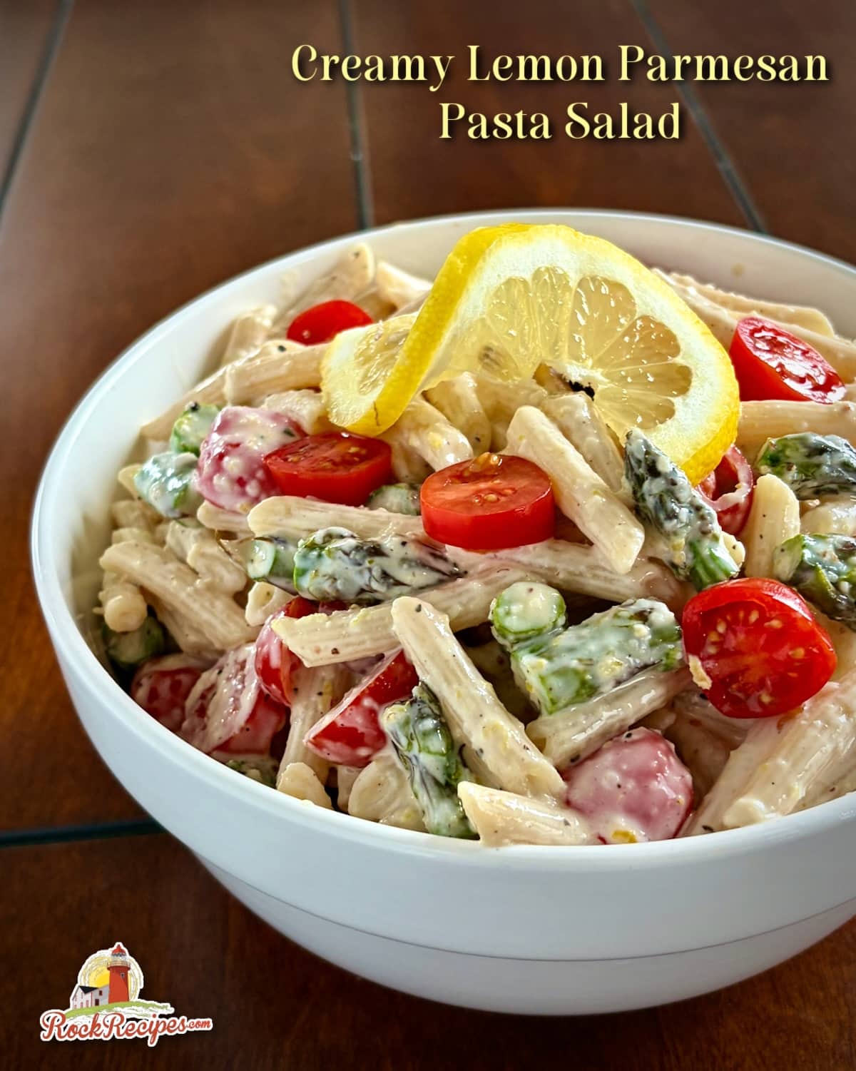 Photo of Lemon Parmesan Pasta Salad in a white bowl with title text added for Pinterest and social media posts.