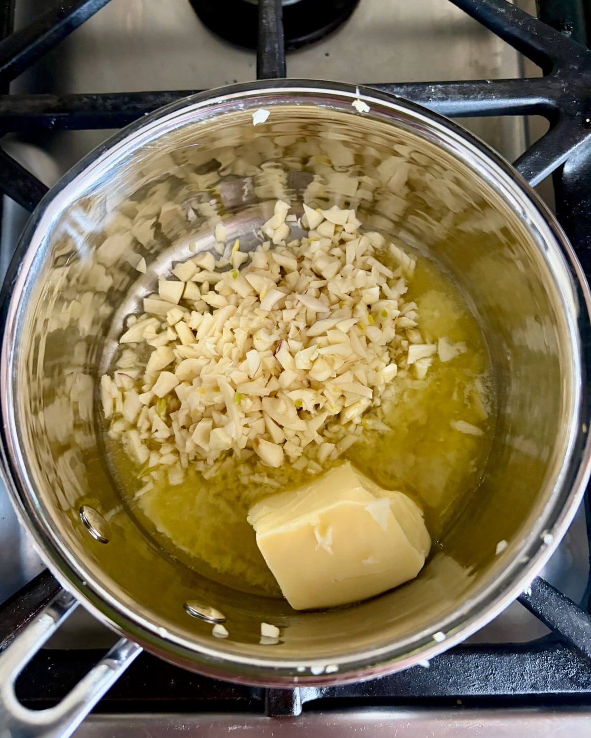 Photo of melting butter and chopped garlic in a small saucepan.