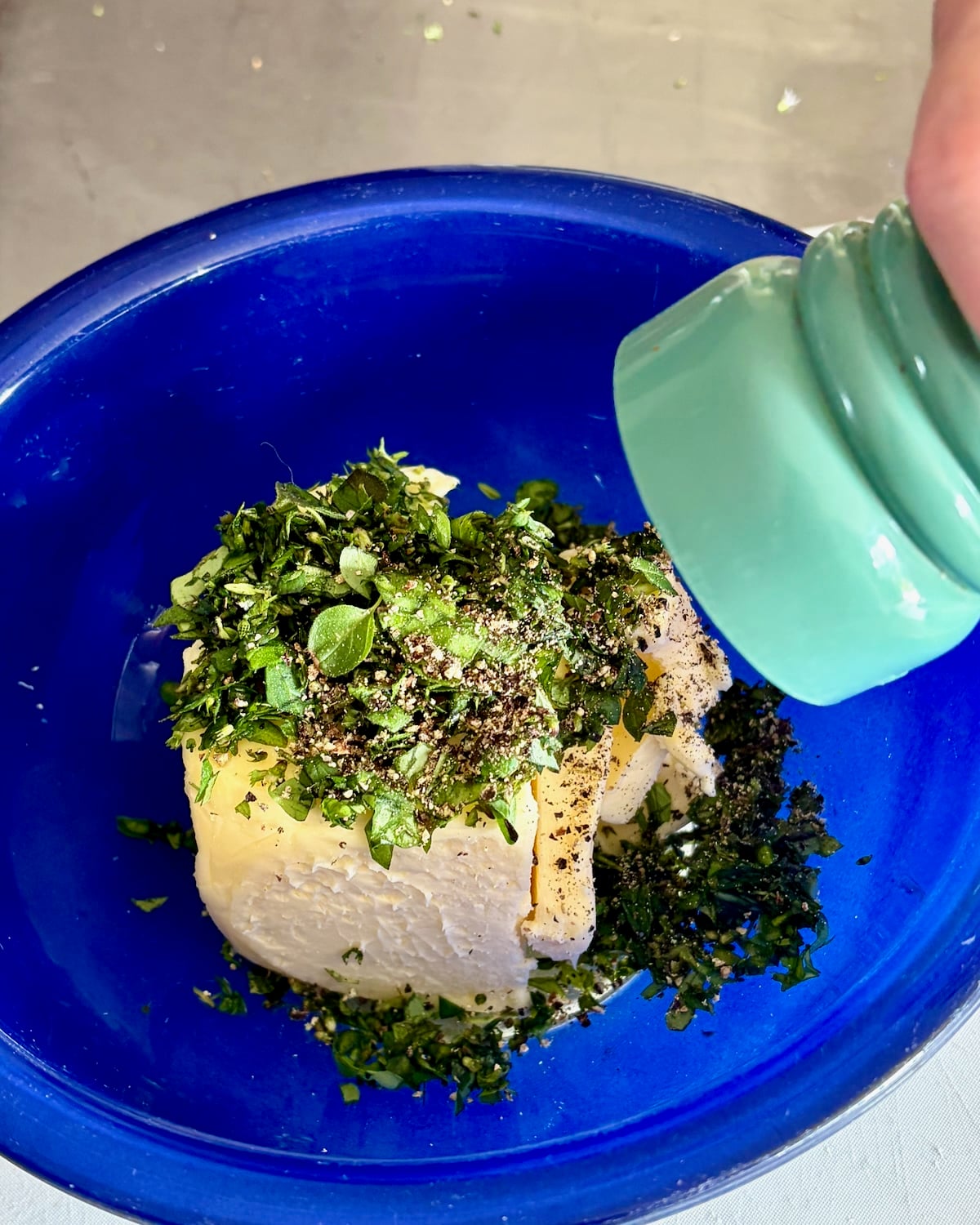 Photo of black peper being added to the butter.