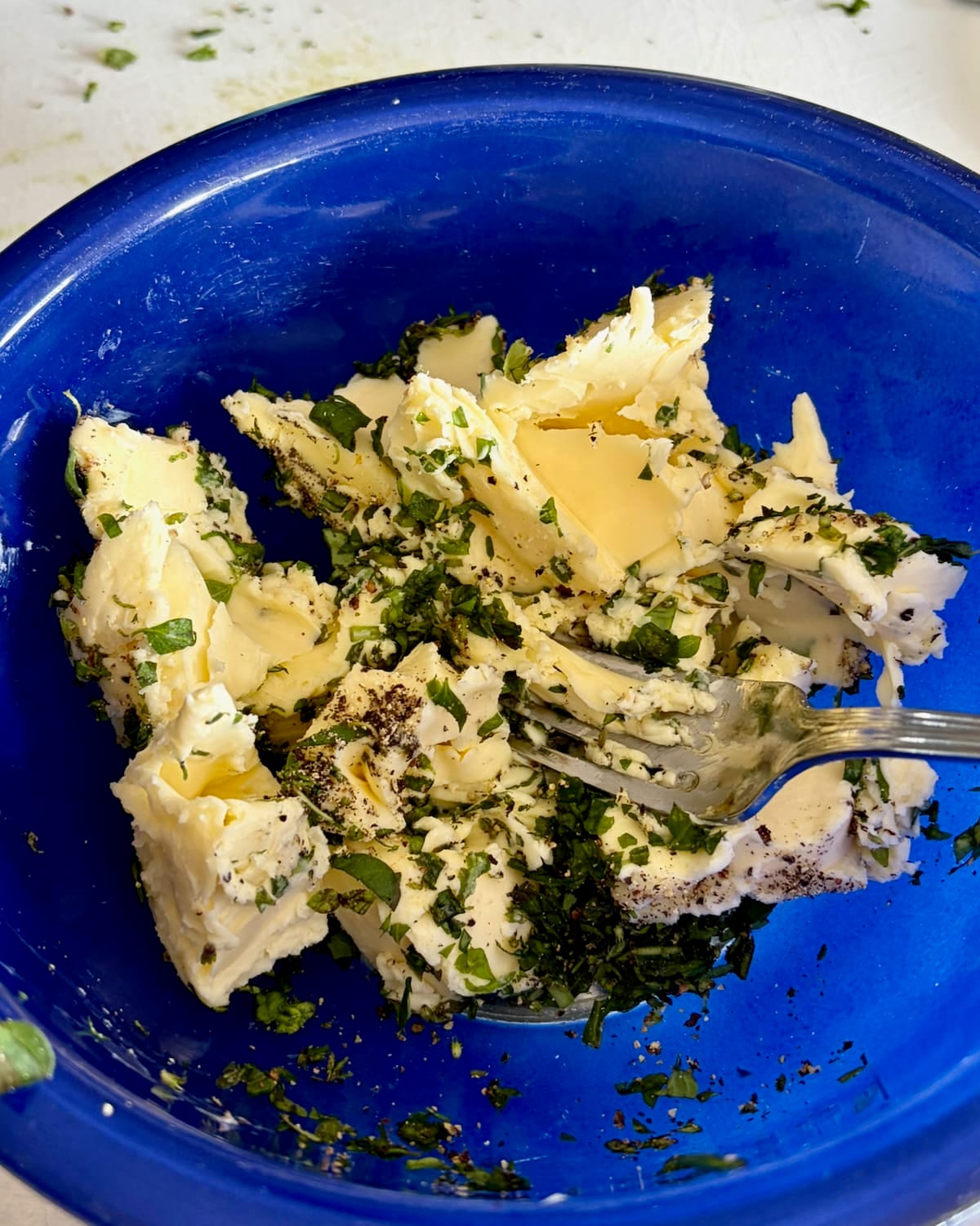 Photo of herbs and pepper mashed into the butter