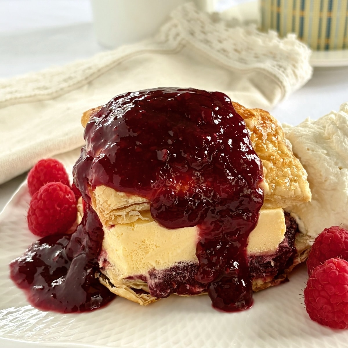 Ice Cream Sandwich Flakies close up photo of one serving with extra sauce and whipped cream.
