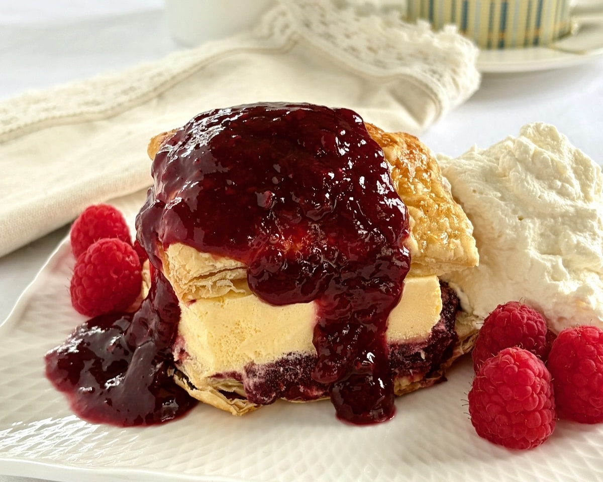Ice Cream Sandwich Flakies wide shot photo of one serving with extra sauce and whipped cream.