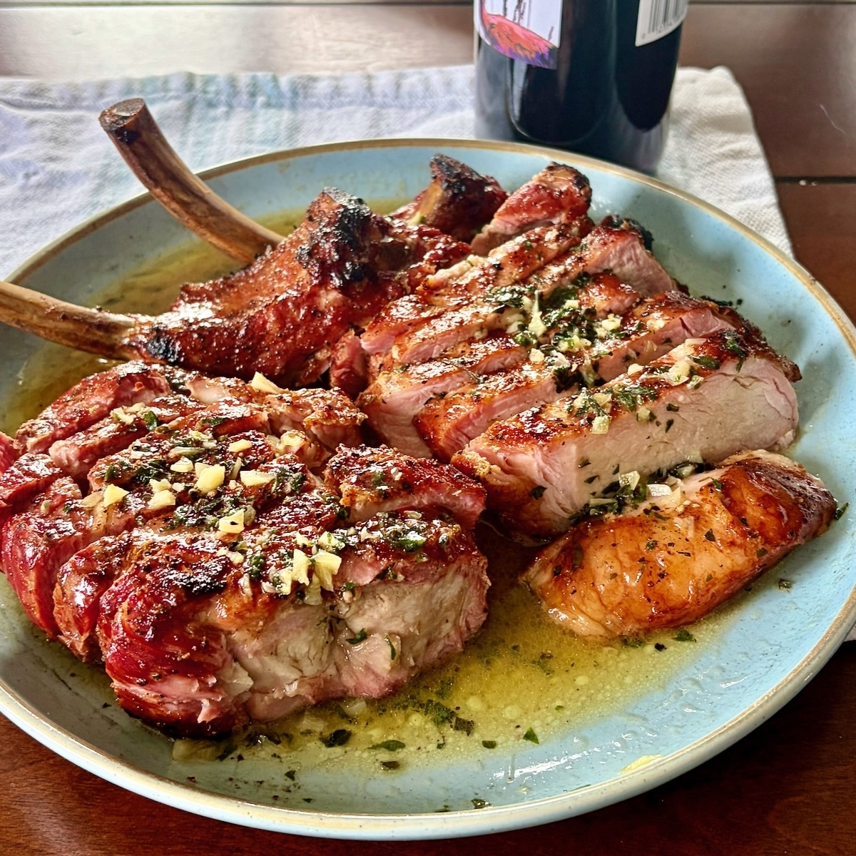 Garlic Herb Butter, photo showing butter melted over smoked and grilled Nagano Pork Chops
