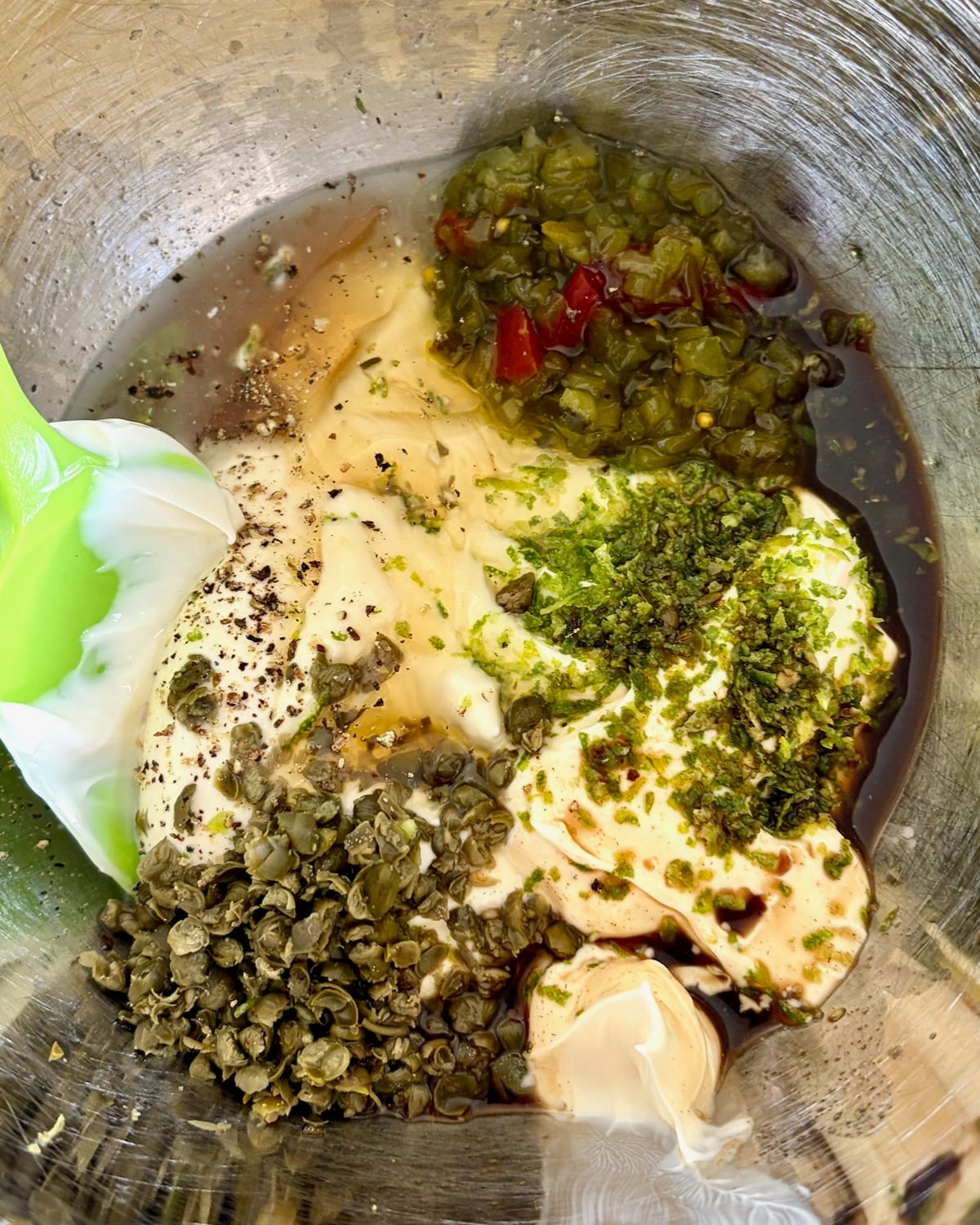 Photo of ingredients for Lime Caper Tartar Sauce in a stainless steel bowl.