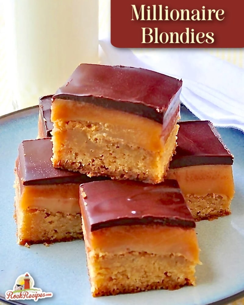 close up ohoto of Millionaire Blondies photo of 5 cookie bars stacked on a blue plate with a glass of milk in the background with title text aand Rock Recipes logo added for social media posts and Pinterest.