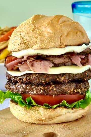 Montreal Smoked Meat Burger shown on a wooden cutting board.