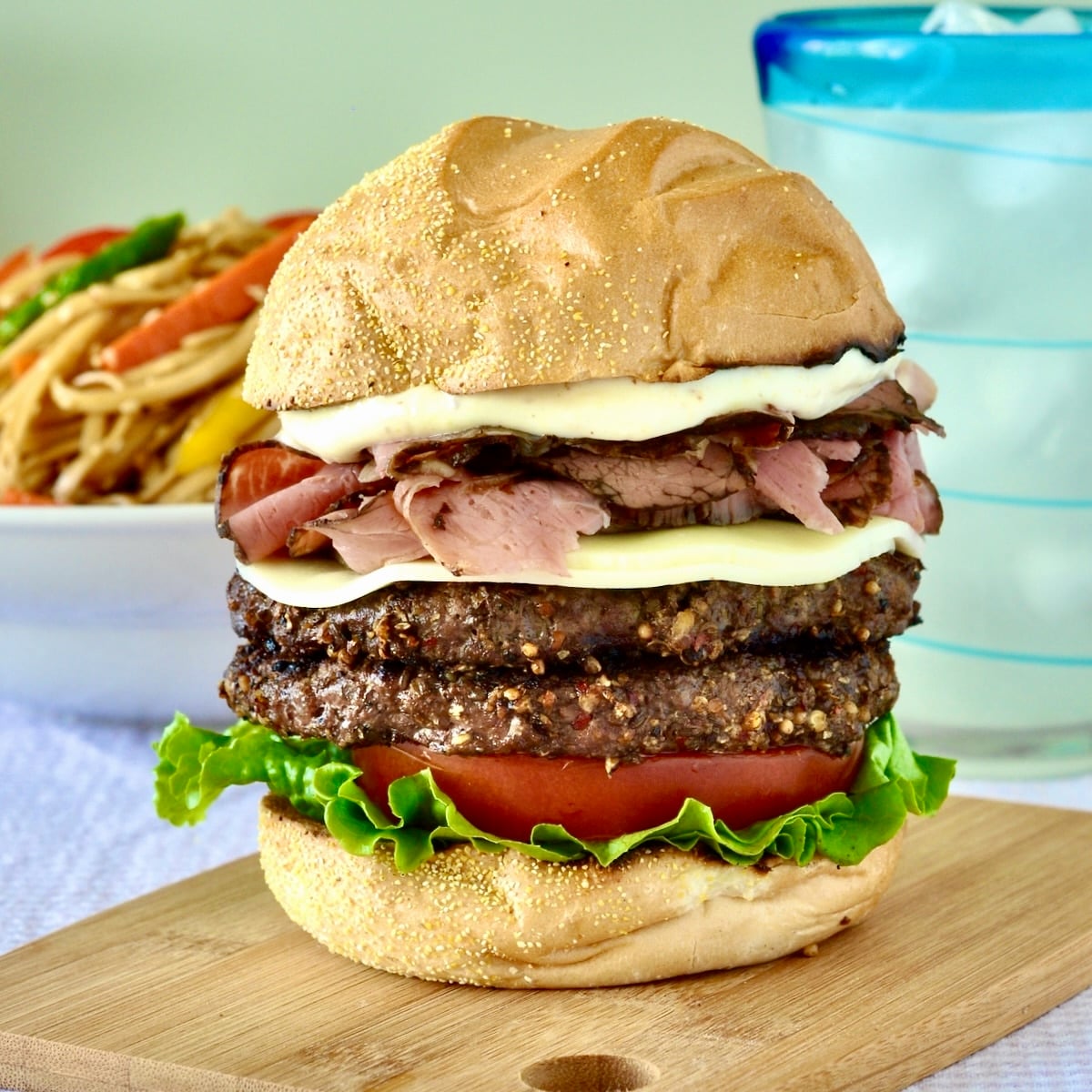 Montreal Smoked Meat Burger shown on a wooden cutting board.