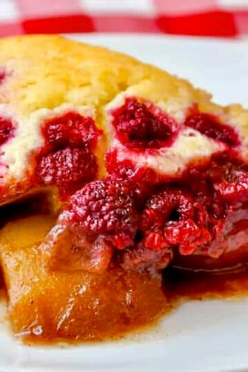 Spiced Pear Cobbler with Raspberries close up photo of one serving in a white plate