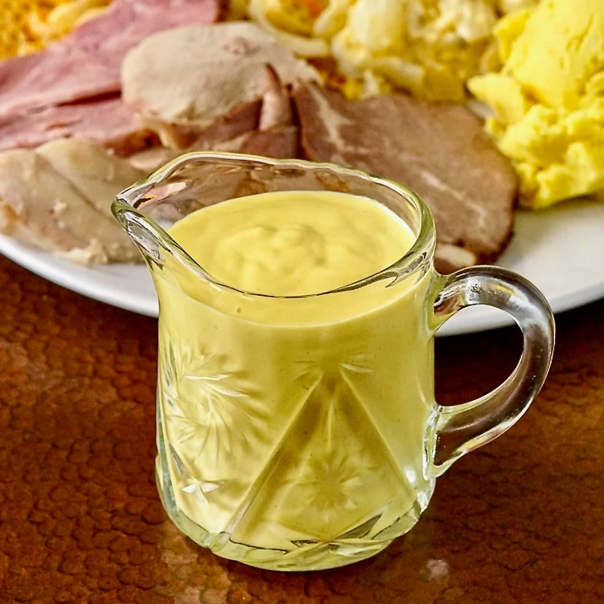 Sweet Mustard Sauce shown in small crystal glass jug