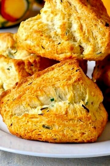 Buttermilk Chive Biscuits close up photo of biscuits on a white plate