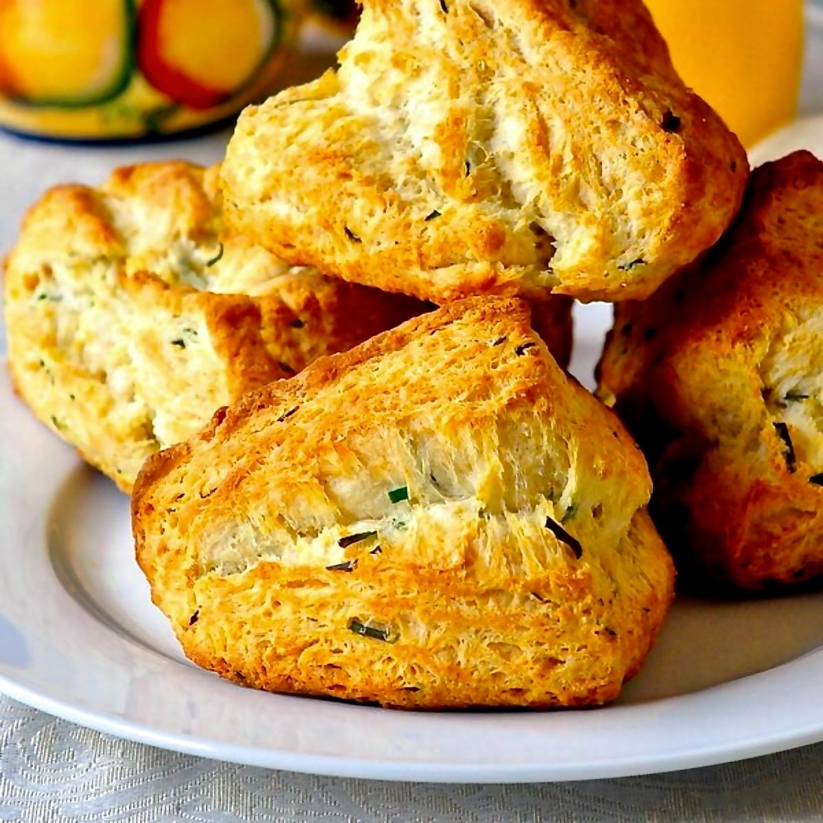 Buttermilk Chive Biscuits close up photo of biscuits on a white plate