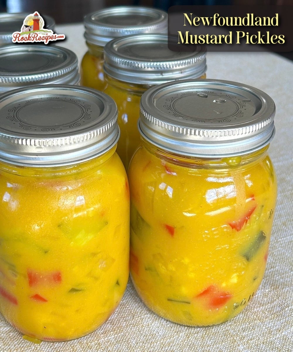 Bottles of completed mustard pickles with title text added for Pinterest and social media posts.