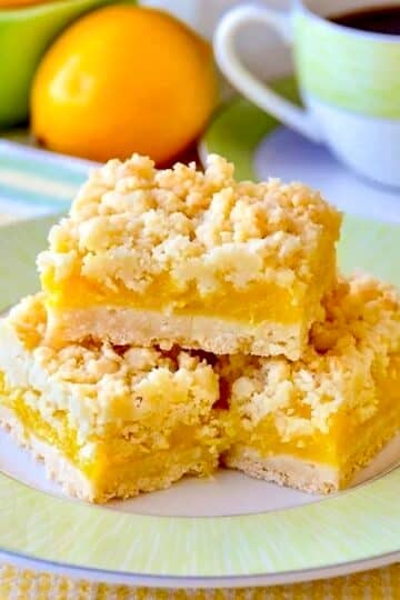 Coconut Lemon Crumble Bars square cropped image of cookies stacked on a green rimmed plate