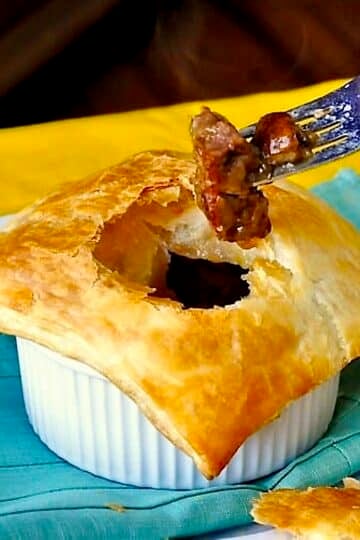 Easy Steak and Onion Pie photo with fork in pie.