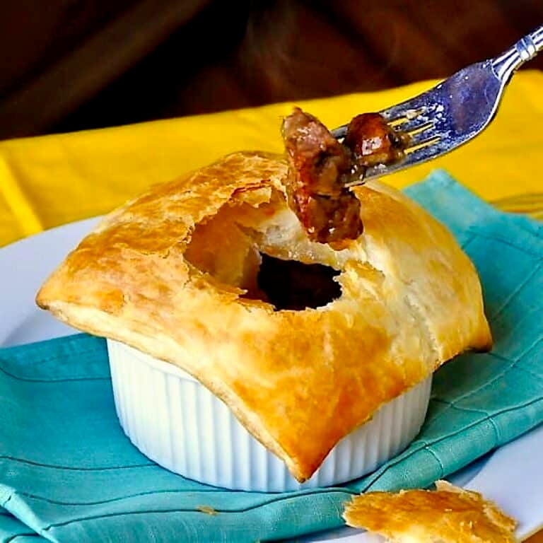 Easy Steak and Onion Pie photo with fork in pie.