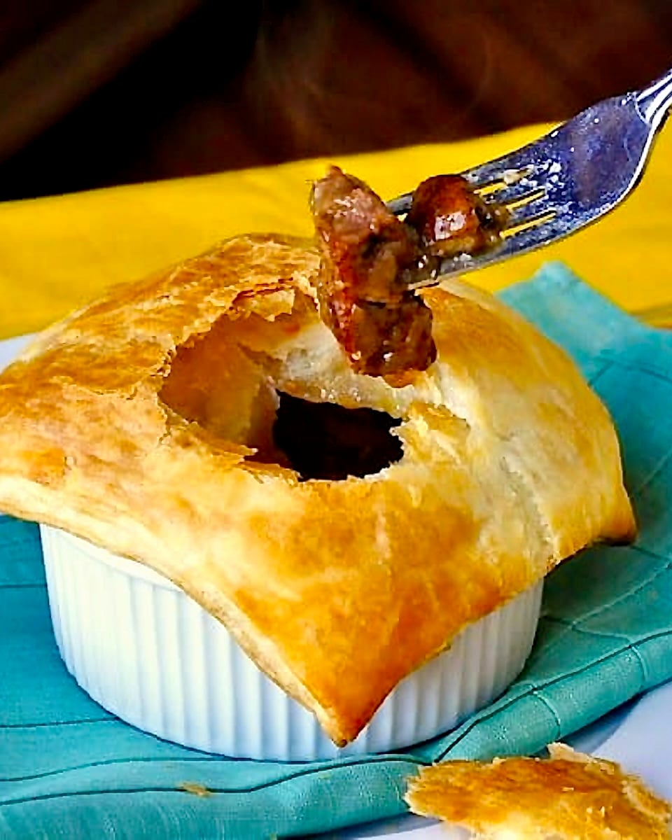 Close up photo of Easy Steak and Onion Pie with fork in pie