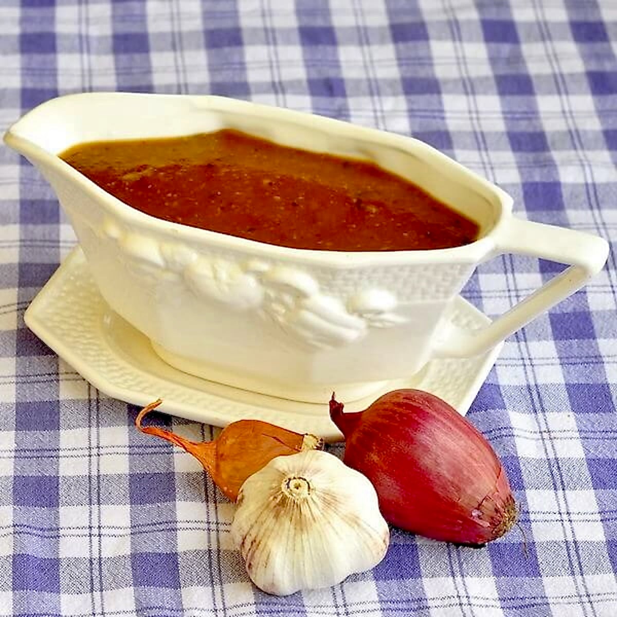 Vegetarian Onion Gravy in a white gravy boat.