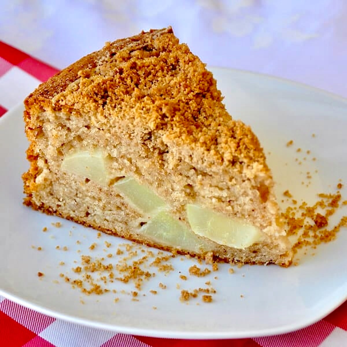 wide shot Streusel Spice Pear Cake photo of one slice on a white plate.