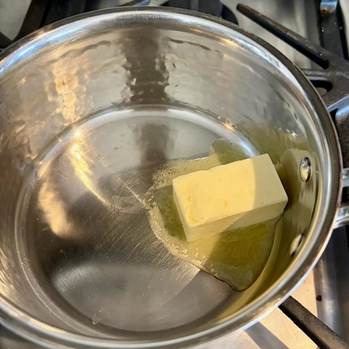 Photo of butter melting in a small saucepan.