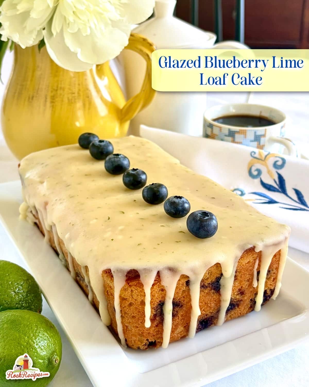 Photo of uncut Glazed Blueberry Lime Loaf Cake with title text added fro Pinterest and social media posts.