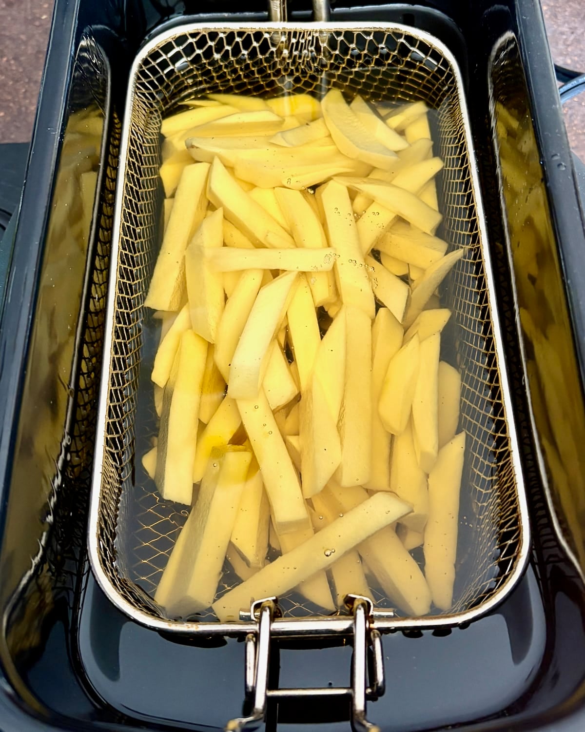 Photo of Cold Oil French Fries submerged in cold oil.
