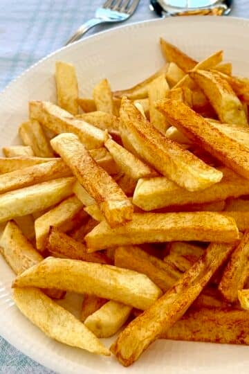 Cold Oil French Fries close up photo of one serving in a white plate.