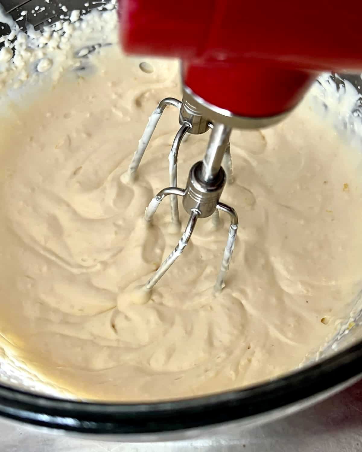 Photo of the cheese mixture for Smoked Fish Dip being creamed with a hand mixer.