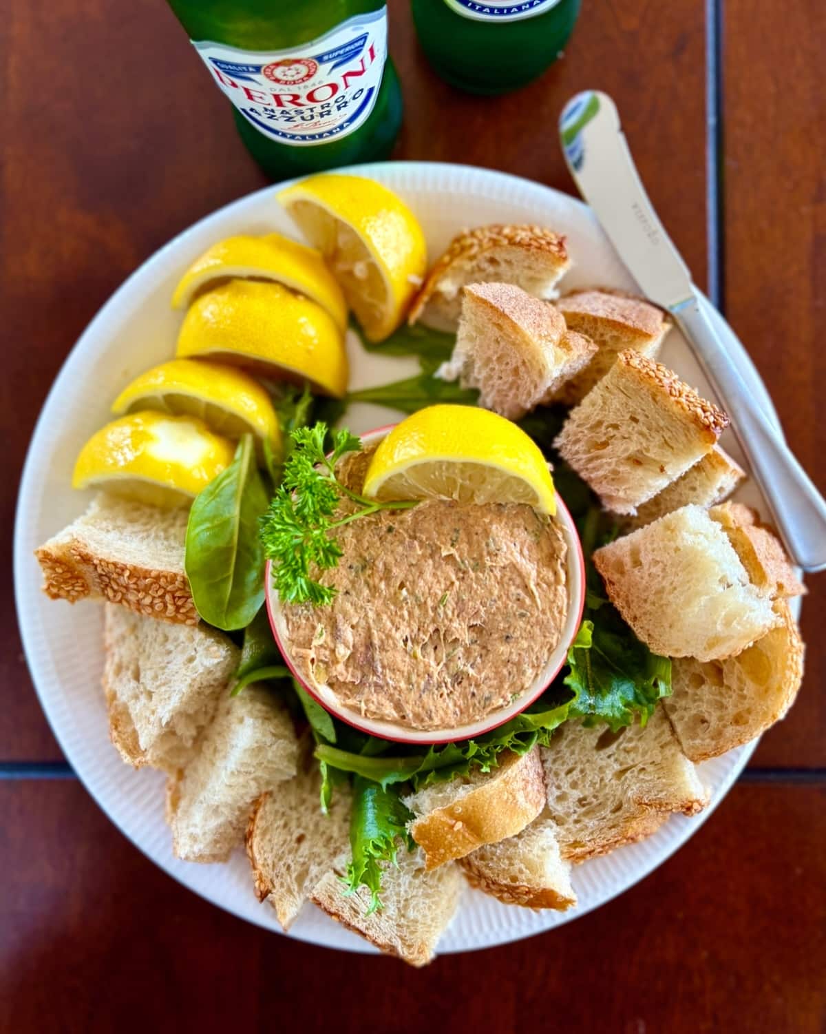 Overhead photo of smoked fish dip with slices and chunks of Belgian bread.