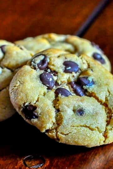 The Best Peanut Butter Chocolate Chip Cookies Close up photo of 1 cookie on a wooden table top.