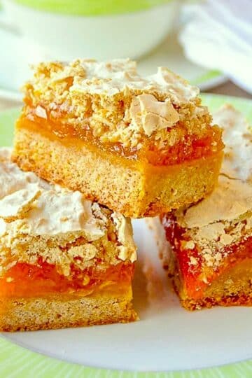 Apricot Coconut Meringue Bars shown with a green and white tea service.