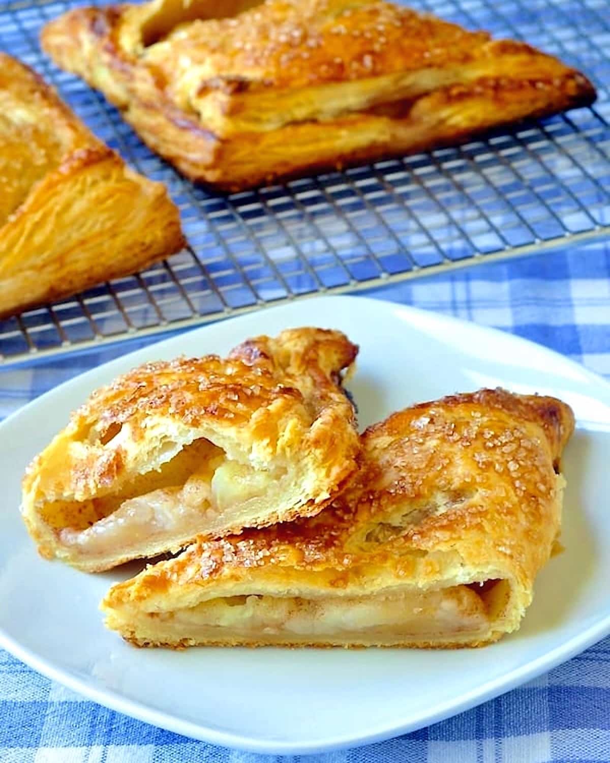 The Best Apple Turnovers close up photo of one turnover showing apple filling for social media posts.