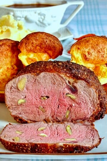 Garlic prime rib sliced open to reveal medium rare interior