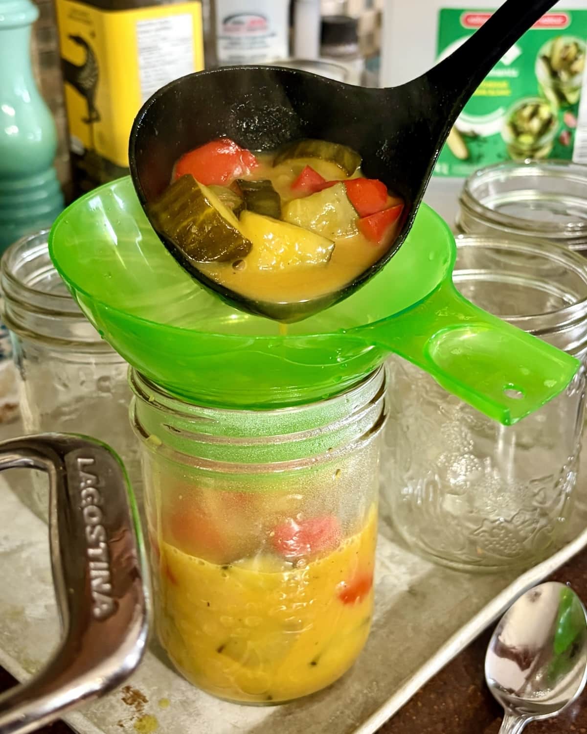 Photo of pickles and funnel while bottling.
