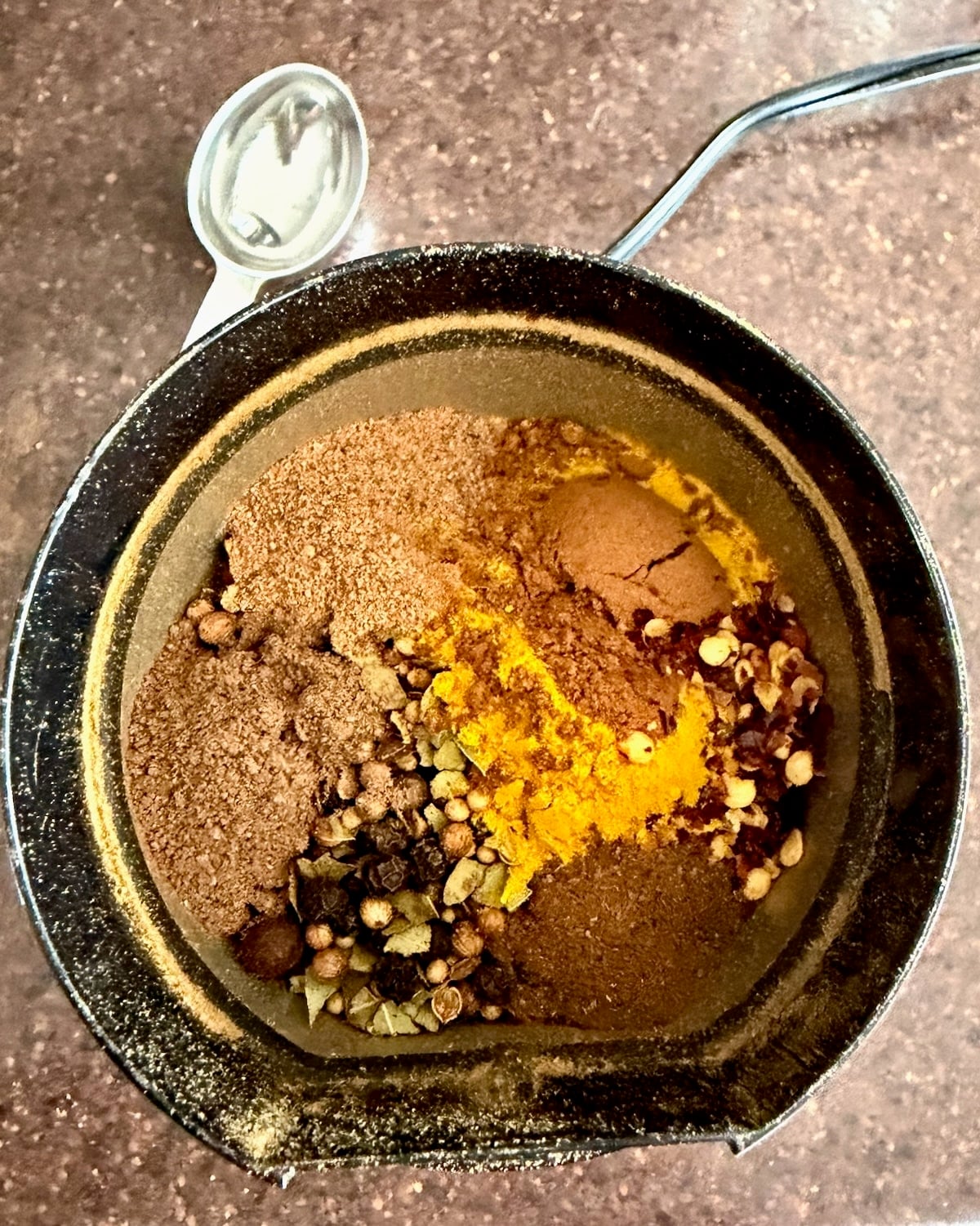 Photo of spices in a spice grinder.