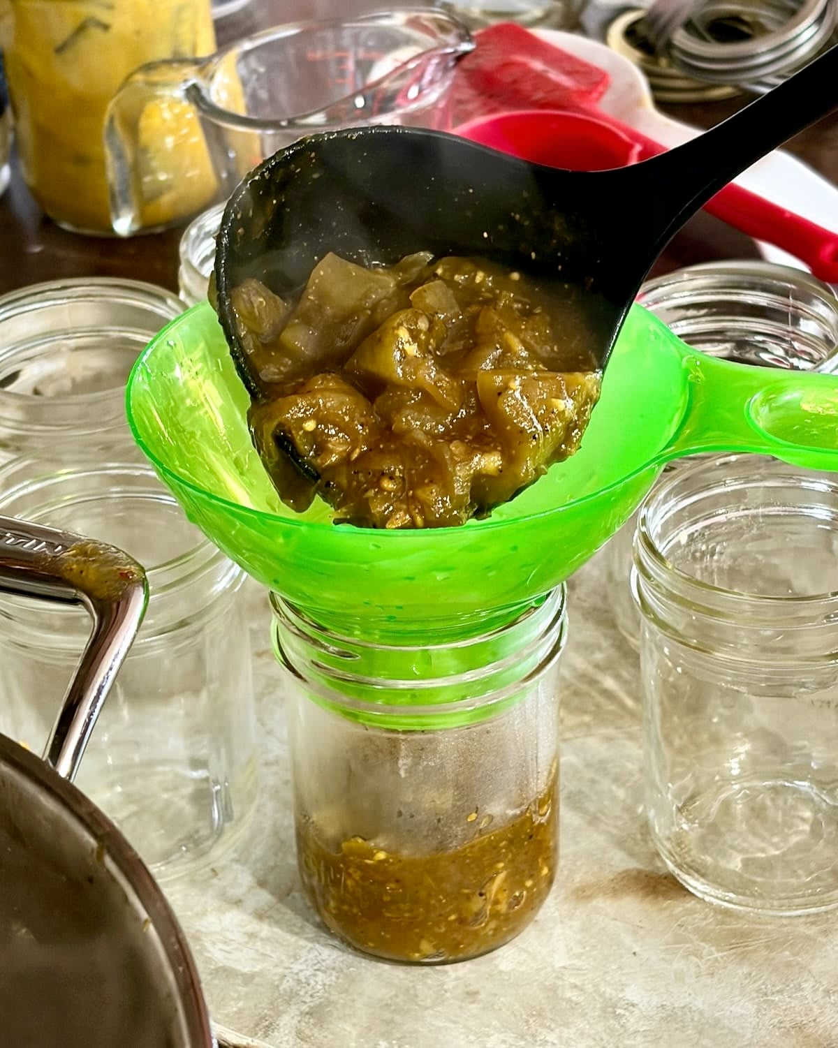 photo of Green Tomato Chow Chow being bottled.