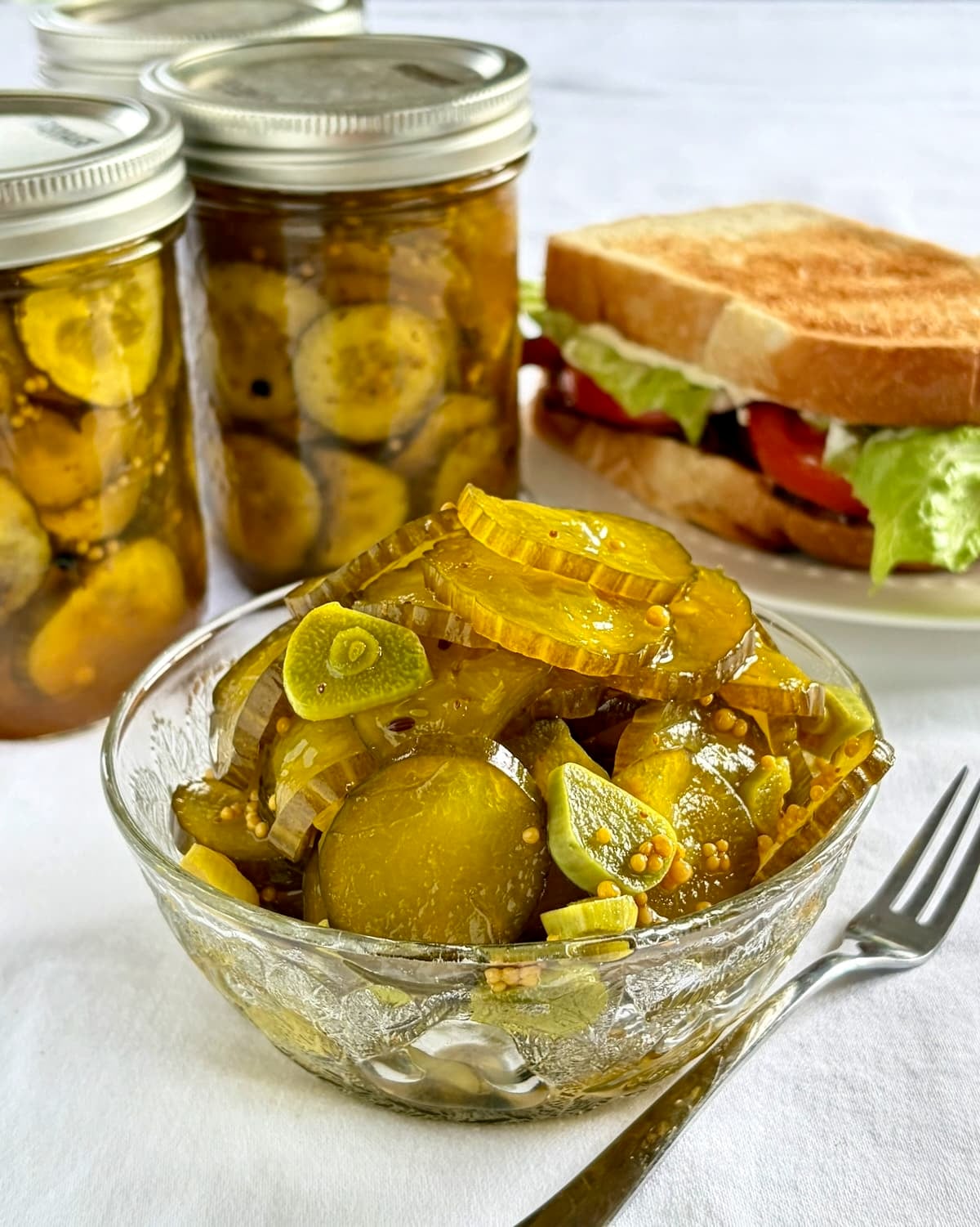 close up photo of a serving bowl of pickles