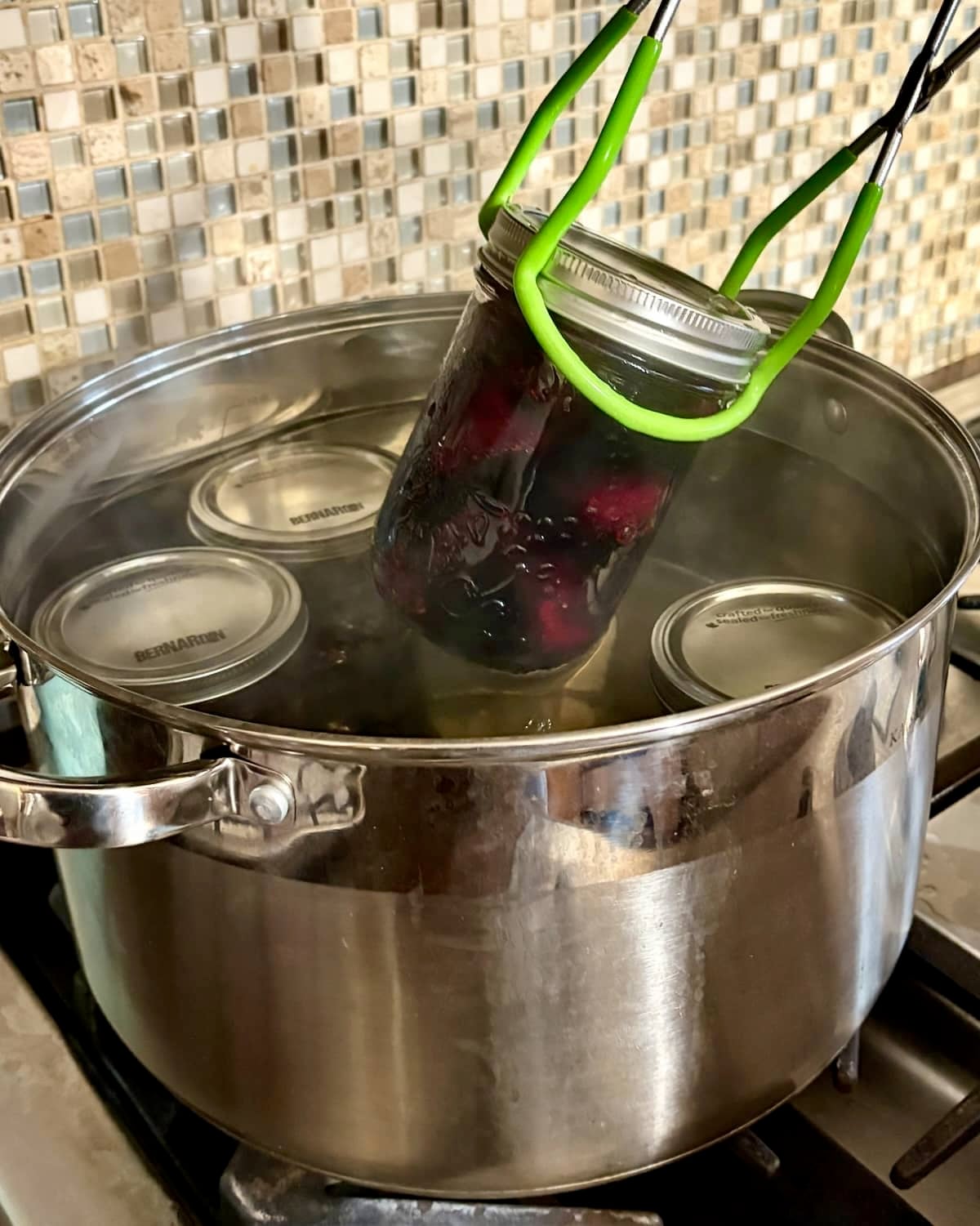 Photo of bottled beets being removed from the water bath.