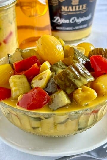 Honey Dijon Mustard Pickles. Close up photo in a vintage glass bowl.
