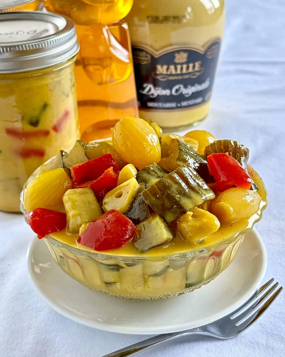 Honey Dijon Mustard Pickles. Close up photo in a vintage glass bowl sized for social media posts