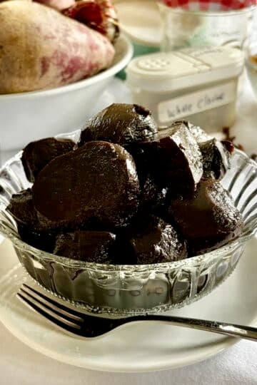 Balsamic Pickled Beets in a clear glass antique serving dish, square cropped for Google featured image.