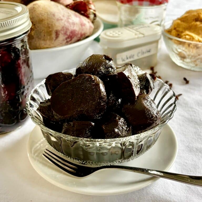 Balsamic Pickled Beets in a clear glass antique serving dish, square cropped for Google featured image.