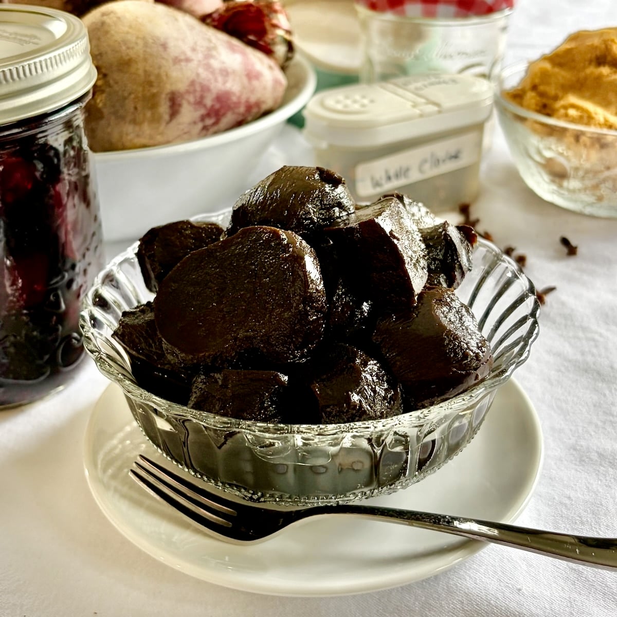 Balsamic Pickled Beets in a clear glass antique serving dish, square cropped for Google featured image.