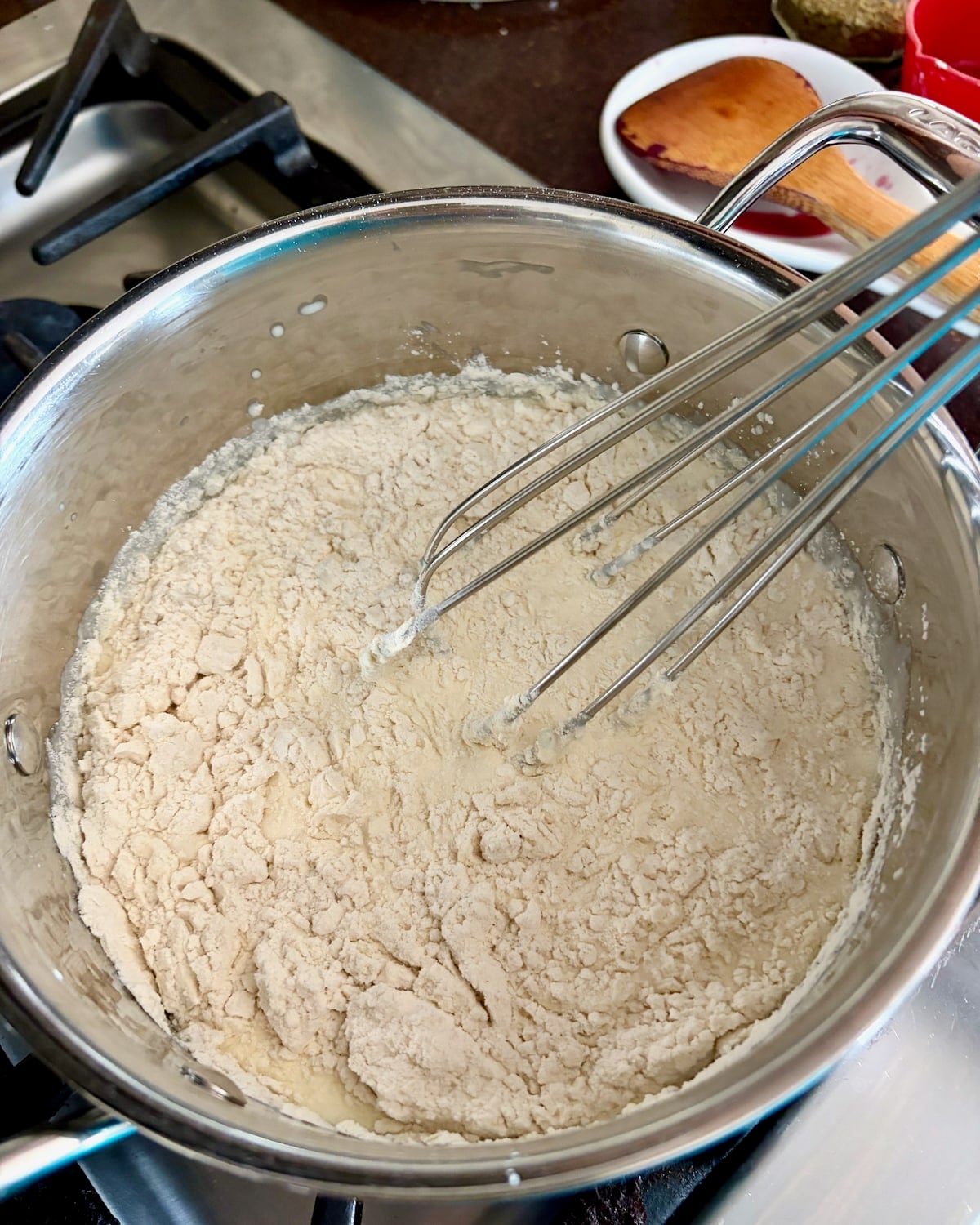 Photo of flour whisking into milk