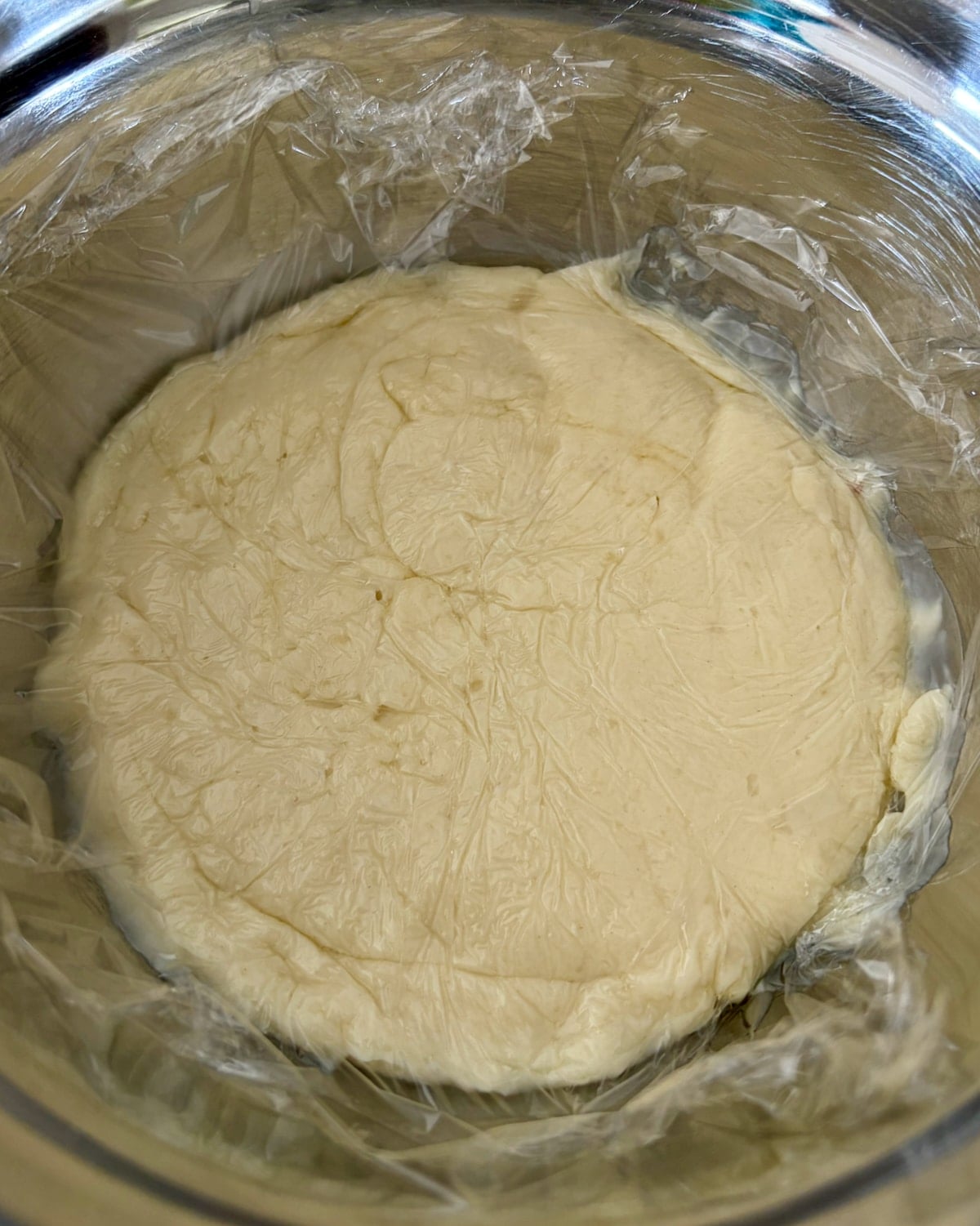 Photo of roux covered in a sheet of plastic wrap.