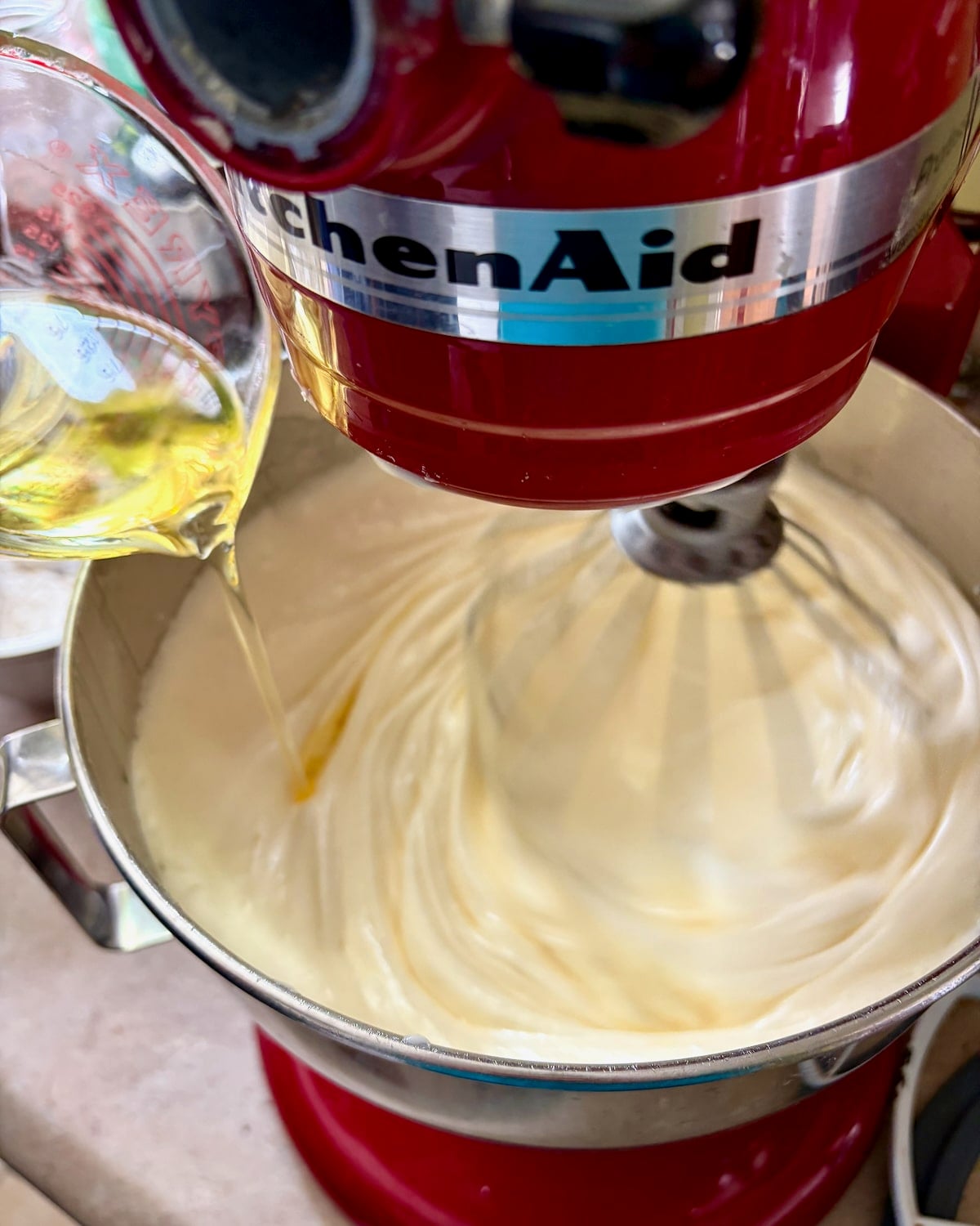 Photo of oil being added to the batter for Vanilla Cloud Cake.