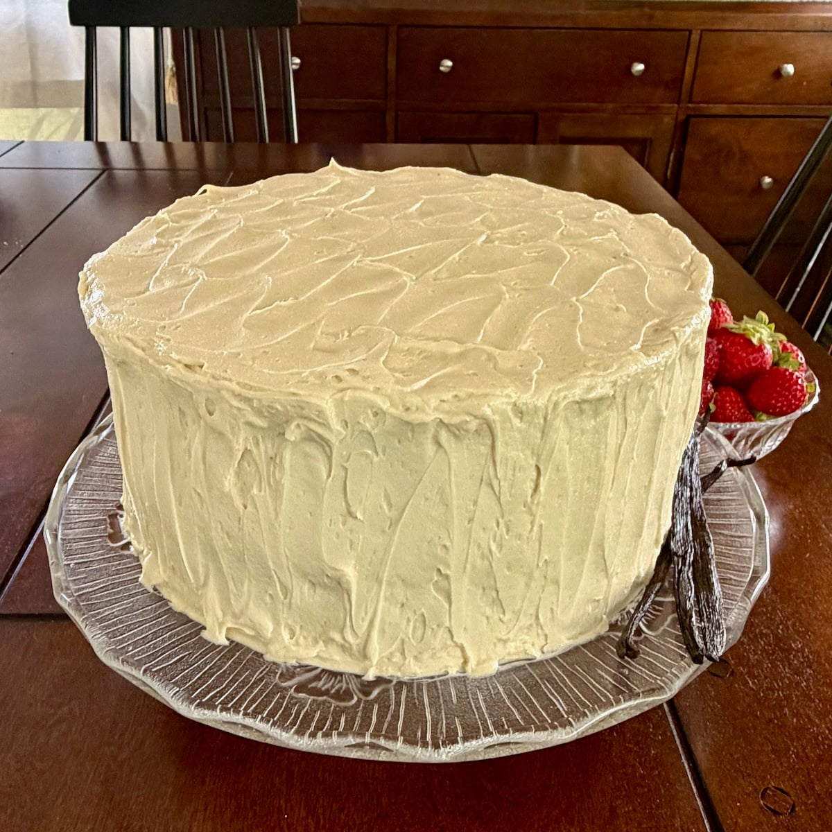 Square cropped photo of Ermine Cream Frosting covering a cake for Google featured image.