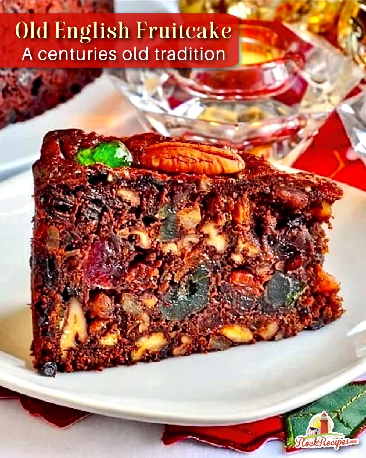Close up photo of one slice of Old English Fruitcake on a white plate with Christmas decorations in background and title text added for Pinterest and social media posts.