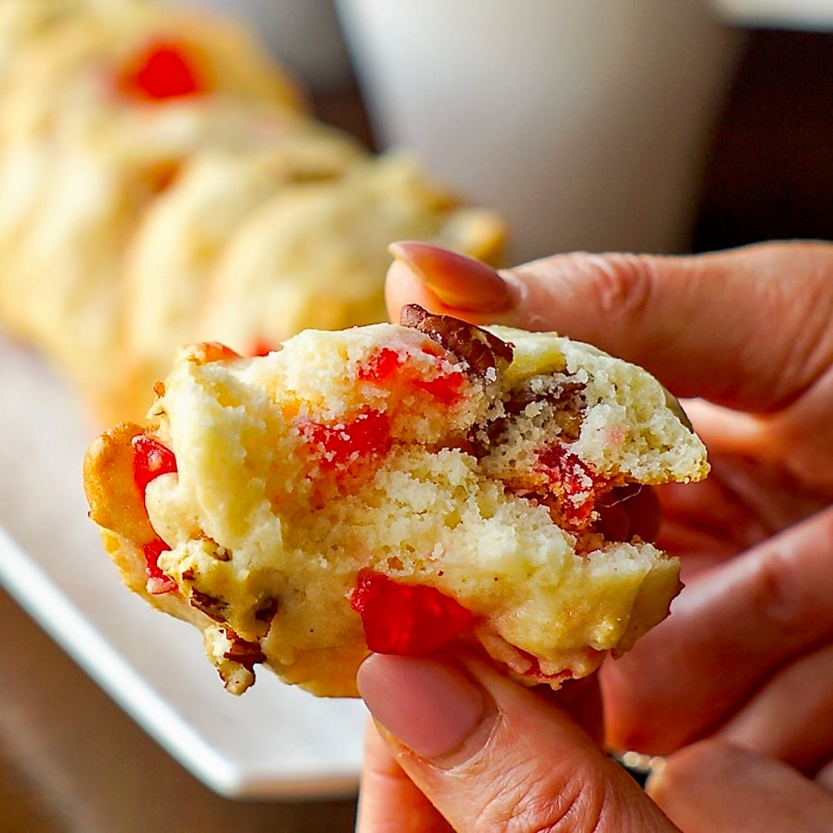 Cookie being broken open to show inside of these soft Cream Cheese Cookies