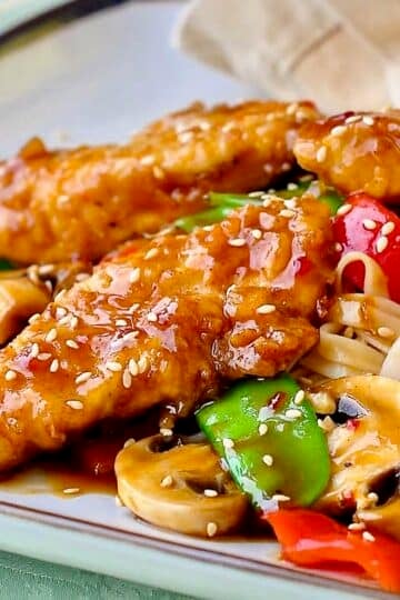 Crispy Oven Baked Low Fat Orange Hoisin Chicken shown on a square plate.