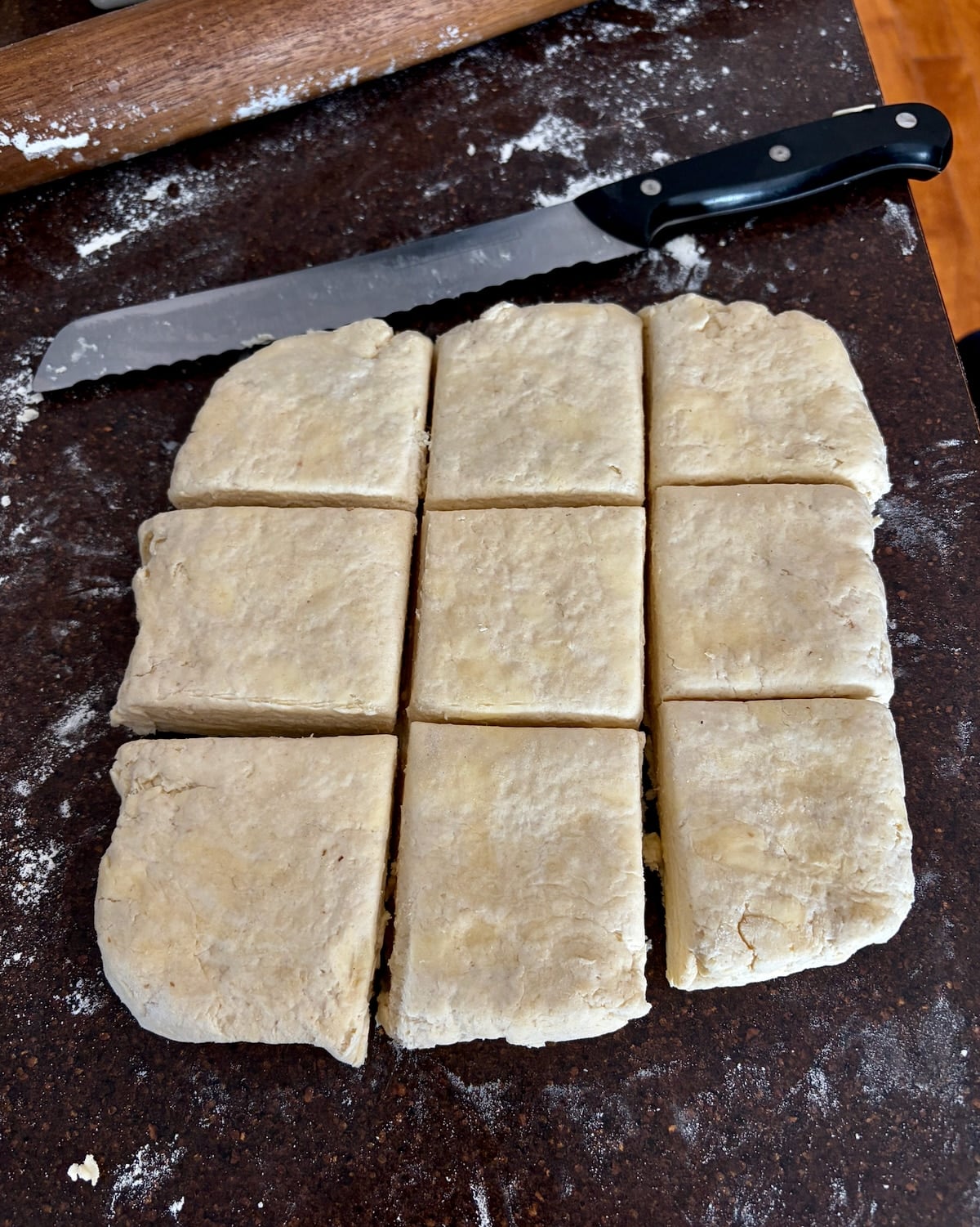Flaky Sour Cream Biscuits dough cut into 9 squares.